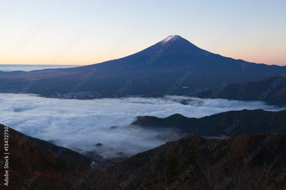 Mountain Fuji and sea of mist above Kawaguchiko lake in morning autumn season