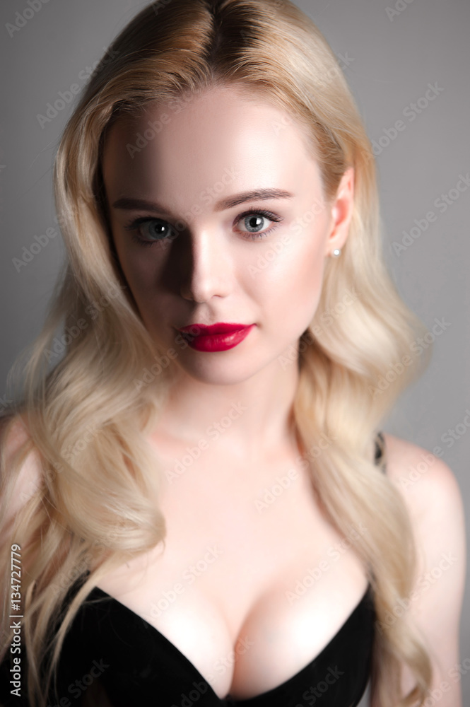 Beauty model girl with perfect make-up red lips and blue eyes looking at camera, wearing magenta bra. Portrait of attractive sexy young woman with blond hair. Fashion retouched close up shot. Beauty model girl with perfect make-up red lips and blue eyes looking at camera, wearing magenta bra. Portrait of attractive sexy young woman with blond hair. Fashion retouched close up shot.