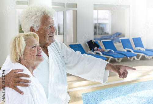 Принти на полотні Senior couple in spa with long chair on backgroung
