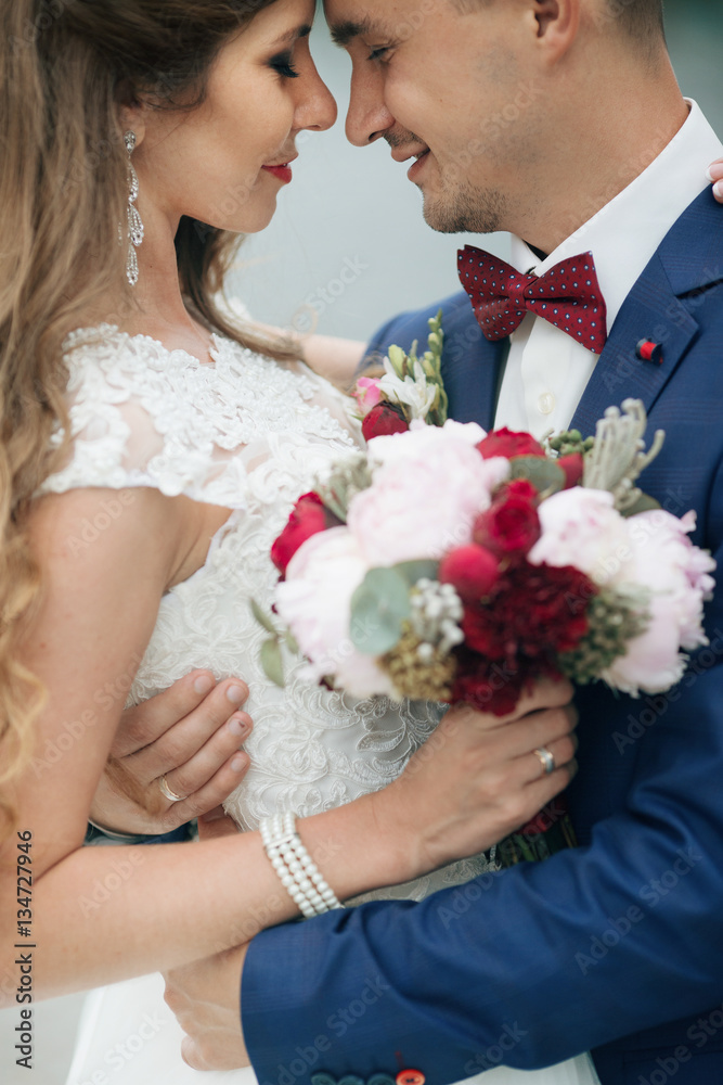 Dreamy newlyweds hug each other tender