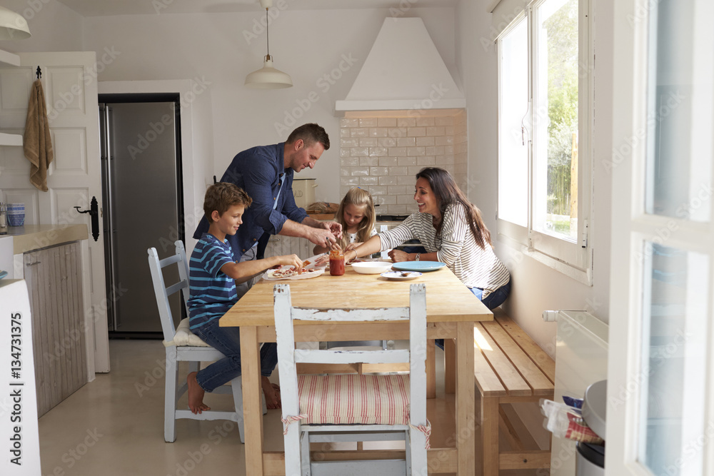 Family At Home In Kitchen Making Pizzas Together Family At Home In Kitchen Making Pizzas Together