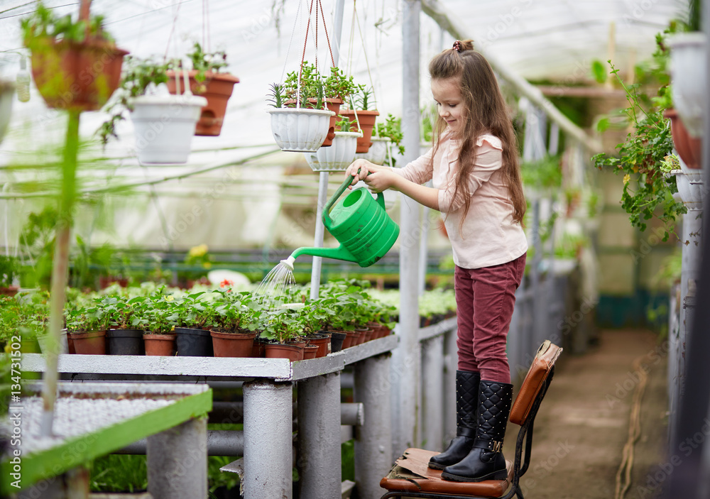 Mother And Daughter Growing Plants In Greenhouse Mother And Daughter Growing Plants In Greenhouse