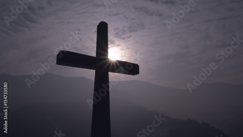 Christian cross with sun in background