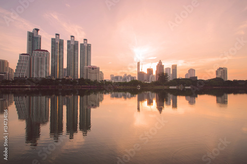city building at morning with warm sunshine. © thithawat