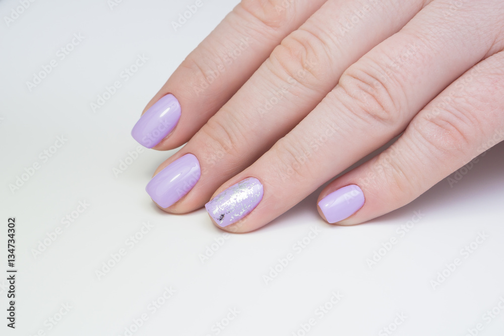 Beautiful natural nails, hand and ideal clean manicure. Decorated with stylish elements Beautiful natural nails, hand and ideal clean manicure. Decorated with stylish elements