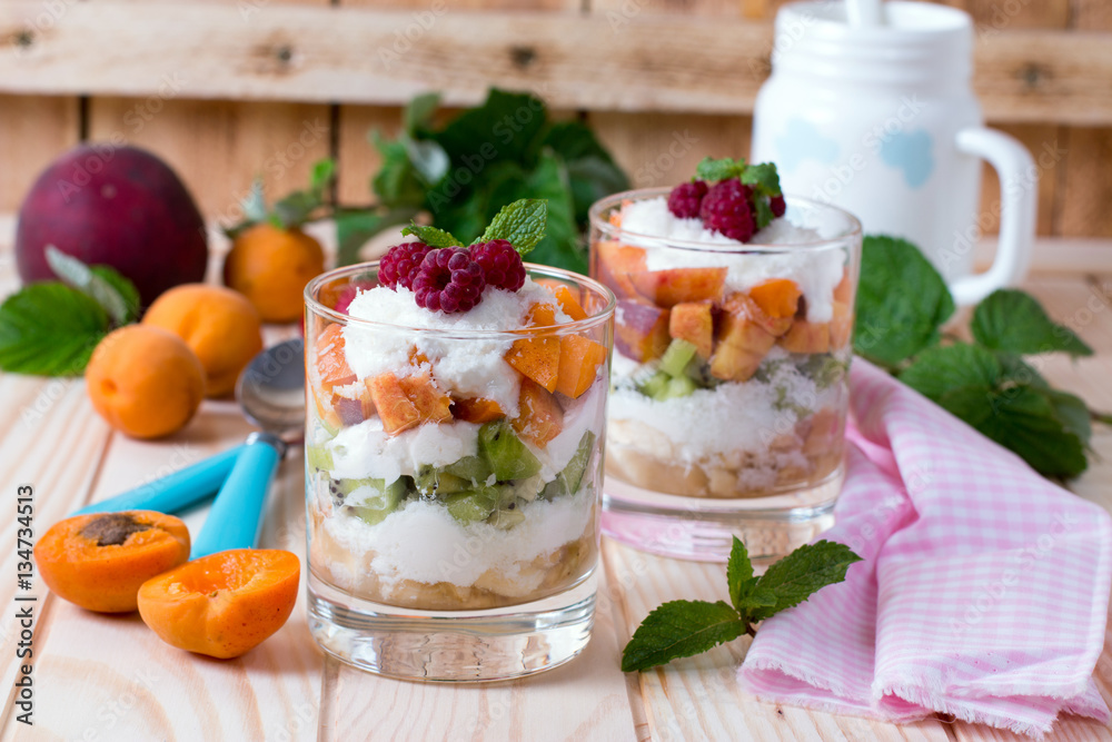 glass bowl with fresh fruits salad and berries on white wooden table glass bowl with fresh fruits salad and berries on white wooden table