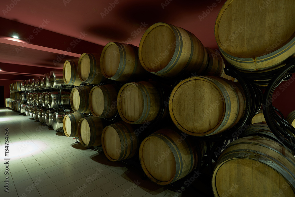 Wooden barrels in the wine cellar Wooden barrels in the wine cellar
