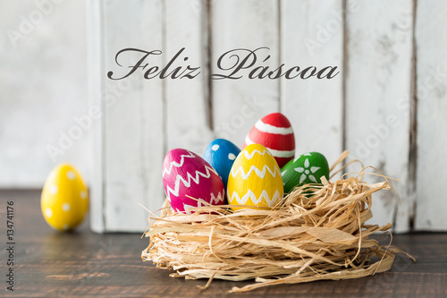 Decorated eggs in raffia nest photo