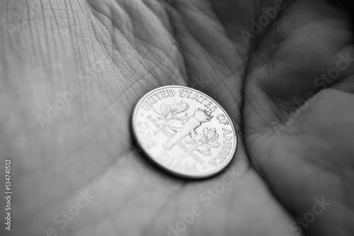 Coin on a palm of a hand - focus on United States of America