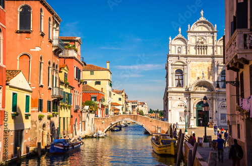 Traditional narrow canal with gondolas in Venice, Italy © Olena Zn