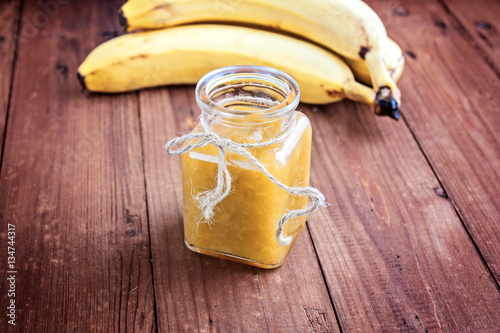 Bananas jam in a glass jar selective focus