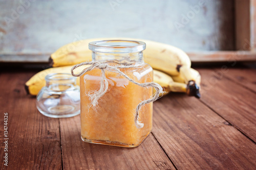 Bananas jam in a glass jar selective focus