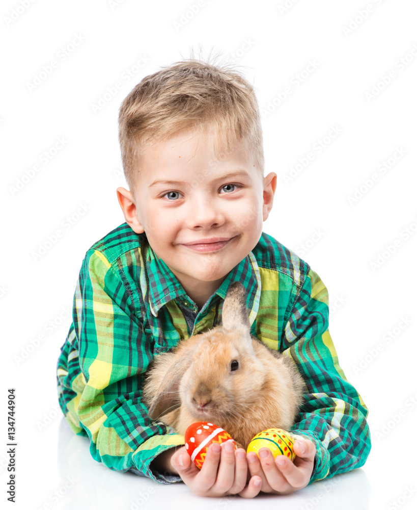 Happy boy with easter eggs embracing rabbit. Isolated on white Happy boy with easter eggs embracing rabbit. Isolated on white