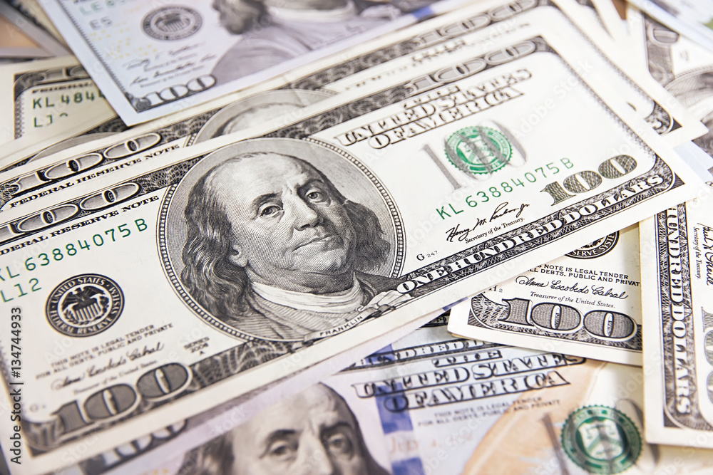 Fototapeta premium Many hundred dollar bills on wooden table