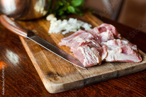 Raw fresh Lamb Meat ribs and seasonings on wooden background.
