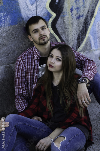Young couple near graffiti wall. Love story