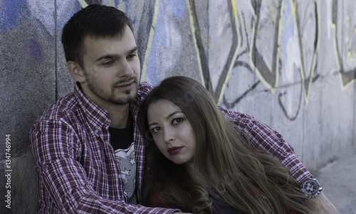 Young couple near graffiti wall. Love story © Imash