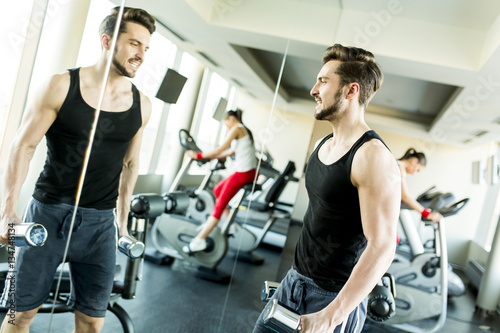 Muscular man training with ...