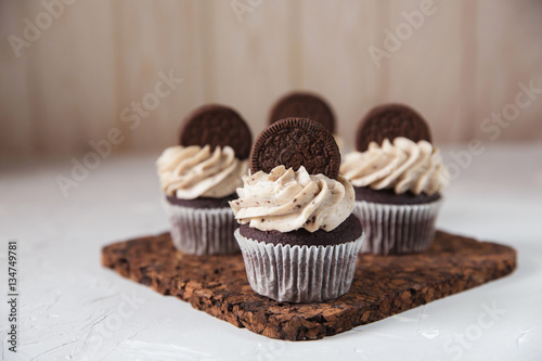 Homemade dark chocolate cupcakes with cookie and cream frosting
