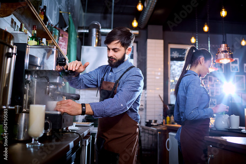 Barman barista uniform making coffee tea cocktails in the bar, restaurant, shop.