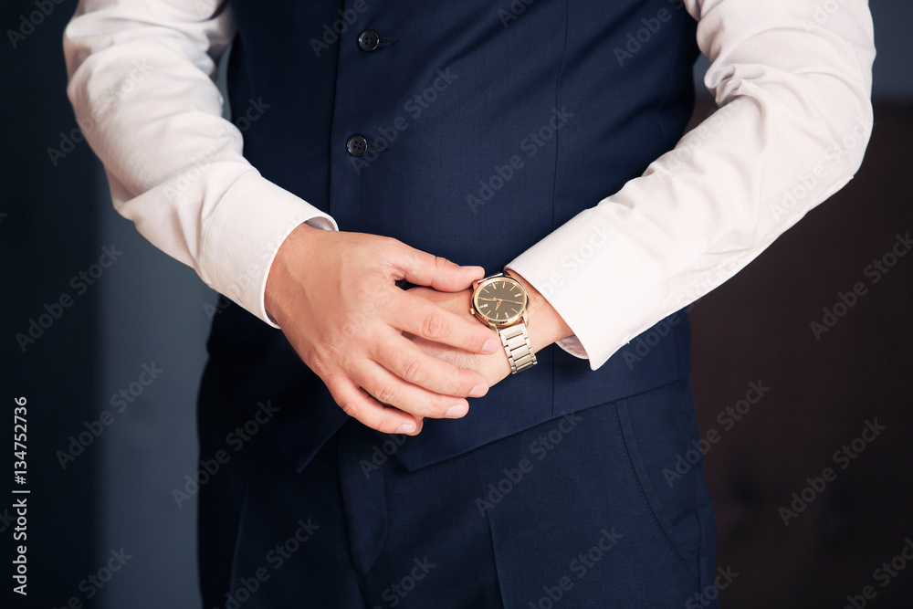 A close up of an expensive elegant watch on a hand of the business man. business concept