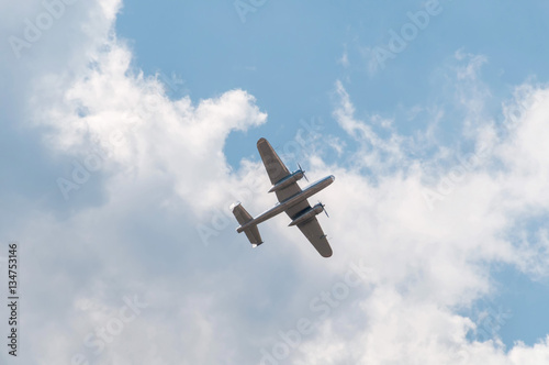 North American B-25 Mitchell twin-engined medium bomber flies against cloudy sky background 