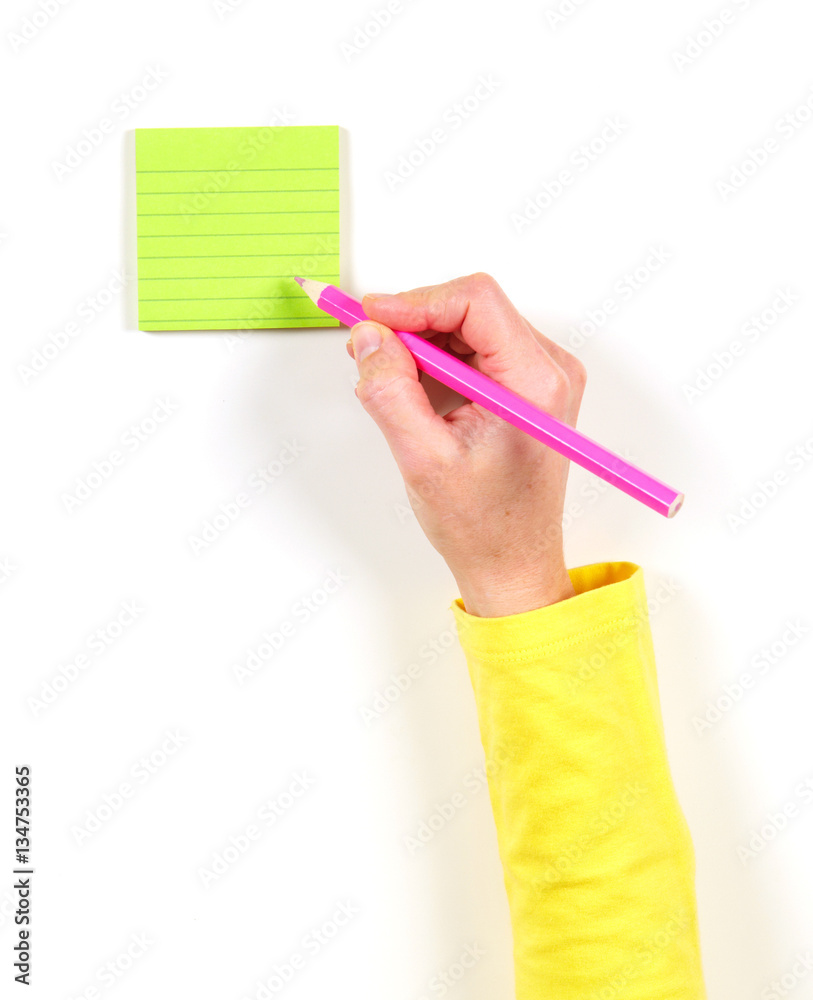 Hand and green paper on the table Hand and green paper on the table