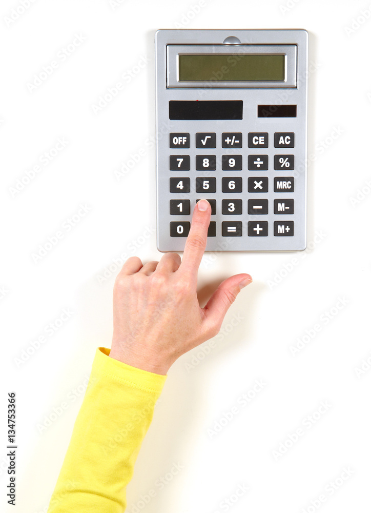 Hands in yellow jacket and grey calculator Hands in yellow jacket and grey calculator