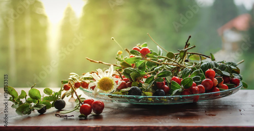 Wild berries cranberries and blueberries on a windowsill.