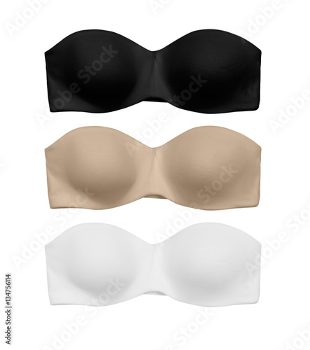 pack of three bandeau bras in black, nude and white isolated on white background photo