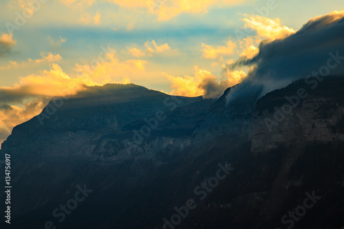 Fototapeta Naklejka Na Ścianę i Meble -  Sunlight breaking through the clouds over a mountain