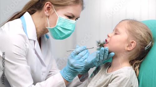 Teeth cure and inspection. Girl patient visiting dentist in dental clinic. 