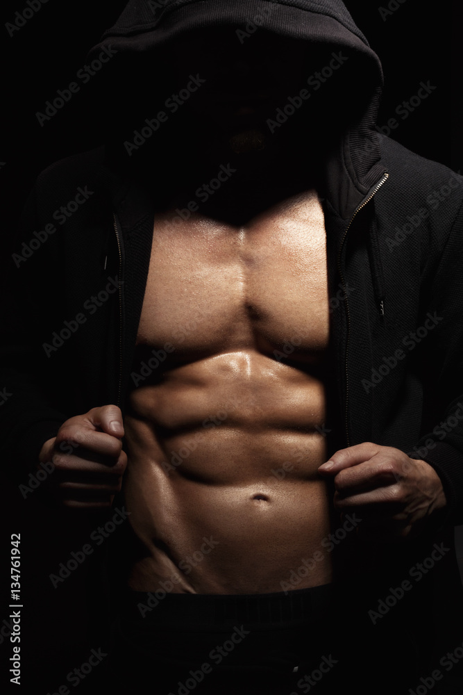 Strong athletic man showes muscular body Strong athletic man showes muscular body