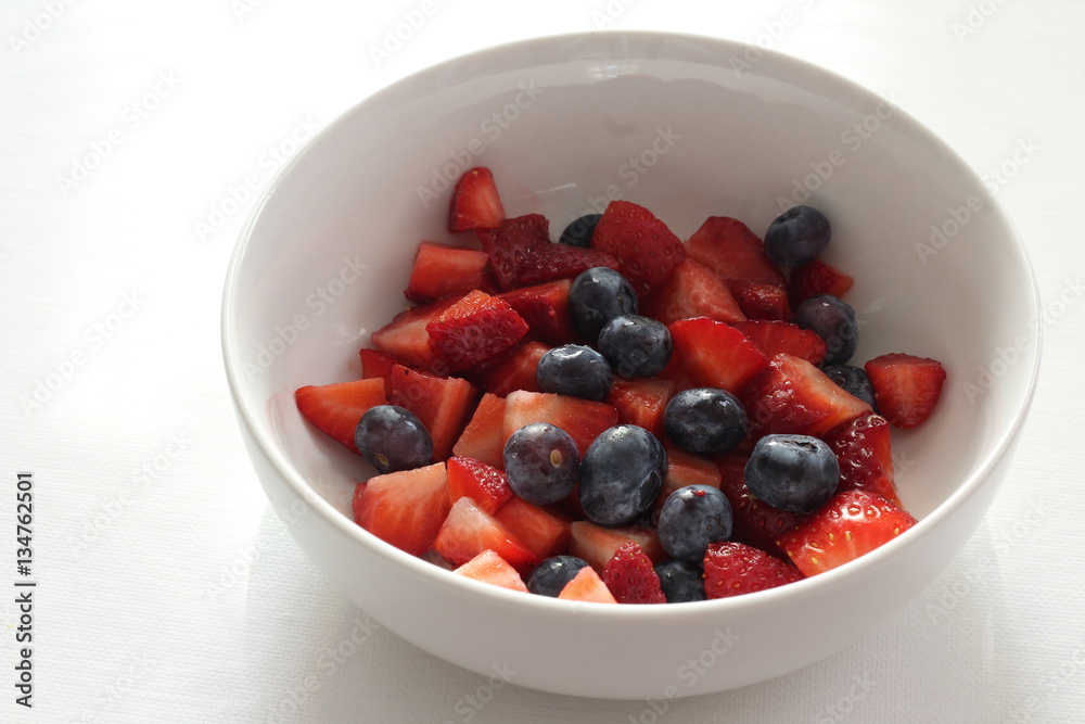 Image of Strawberries and blueberries in white bowl on white background Image of Strawberries and blueberries in white bowl on white background
