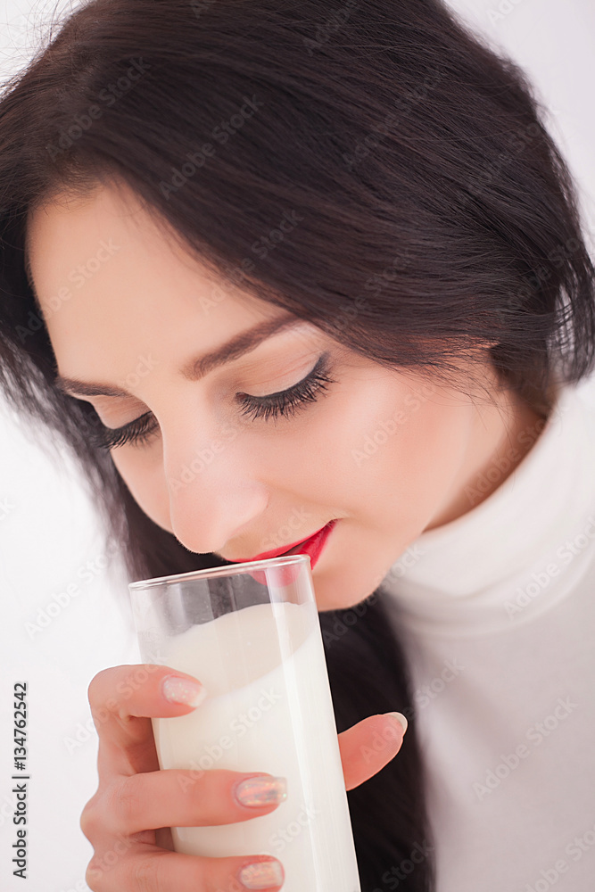 beautiful young woman holding a glass of milk beautiful young woman holding a glass of milk
