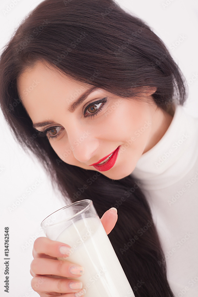 Cute healthy woman is drinking milk from a glass isolated on white background. Cute healthy woman is drinking milk from a glass isolated on white background.