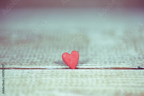 Red heart on wooden texture background. Valentines day concept. Original vintage background. 