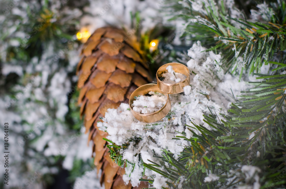 Wedding rings with a bump on the Christmas tree Wedding rings with a bump on the Christmas tree