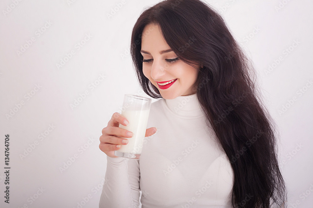 beautiful young woman holding a glass of milk beautiful young woman holding a glass of milk