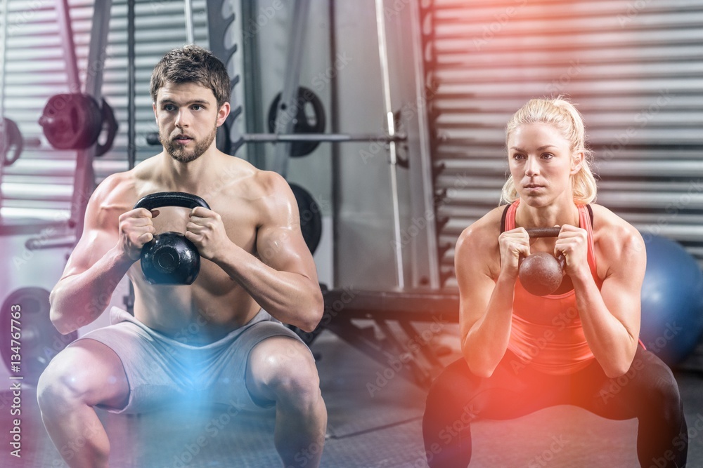 Fototapeta premium Couple lifting dumbbells together