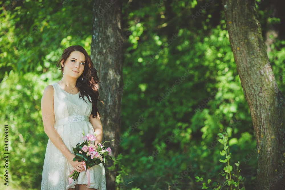 Fashion gorgeous young blonde woman in beautiful white dress in a fairy-tale forest. magic atmosphere Fashion gorgeous young blonde woman in beautiful white dress in a fairy-tale forest. magic atmosphere