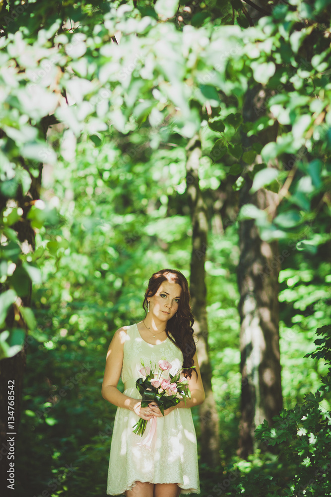 Fashion gorgeous young blonde woman in beautiful white dress in a fairy-tale forest. magic atmosphere Fashion gorgeous young blonde woman in beautiful white dress in a fairy-tale forest. magic atmosphere