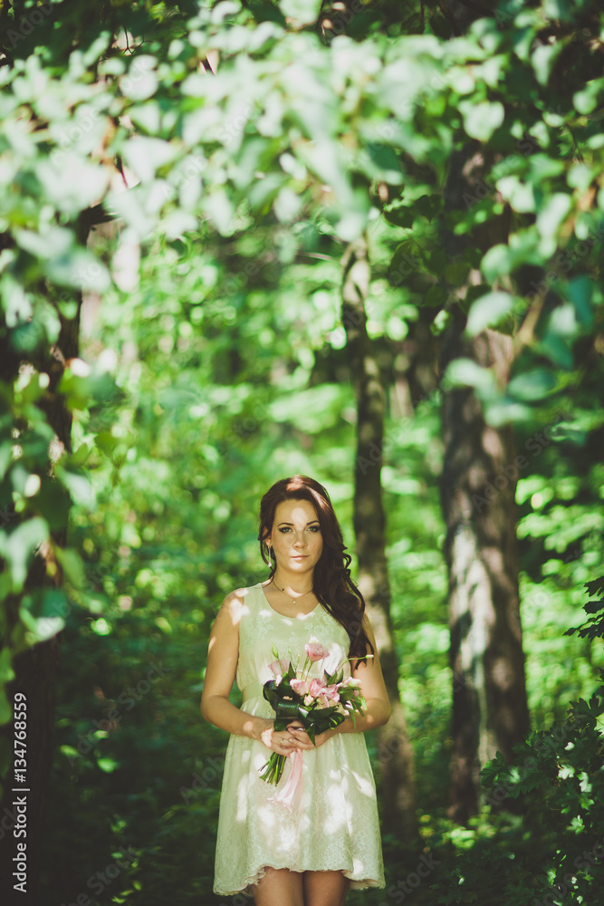 Fashion gorgeous young blonde woman in beautiful white dress in a fairy-tale forest. magic atmosphere Fashion gorgeous young blonde woman in beautiful white dress in a fairy-tale forest. magic atmosphere