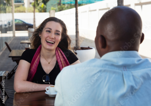 Caucasian woman with brunette hair talking with african american
