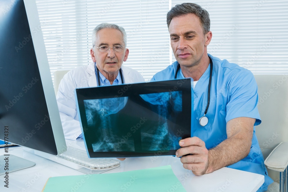 Surgeon and doctor discussing x-ray report Surgeon and doctor discussing x-ray report