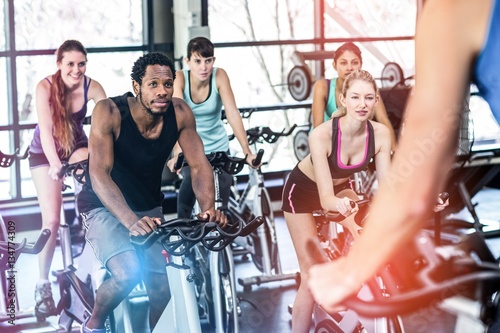 Fit people working out at spinning class photo