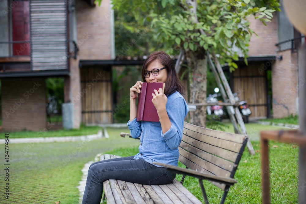 Hipster charming girl relaxing in the park while read book, Enjo Hipster charming girl relaxing in the park while read book, Enjo