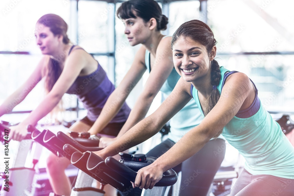 Side view of woman working out at spinning class