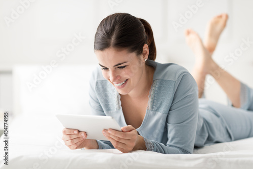 Smiling woman using a tablet