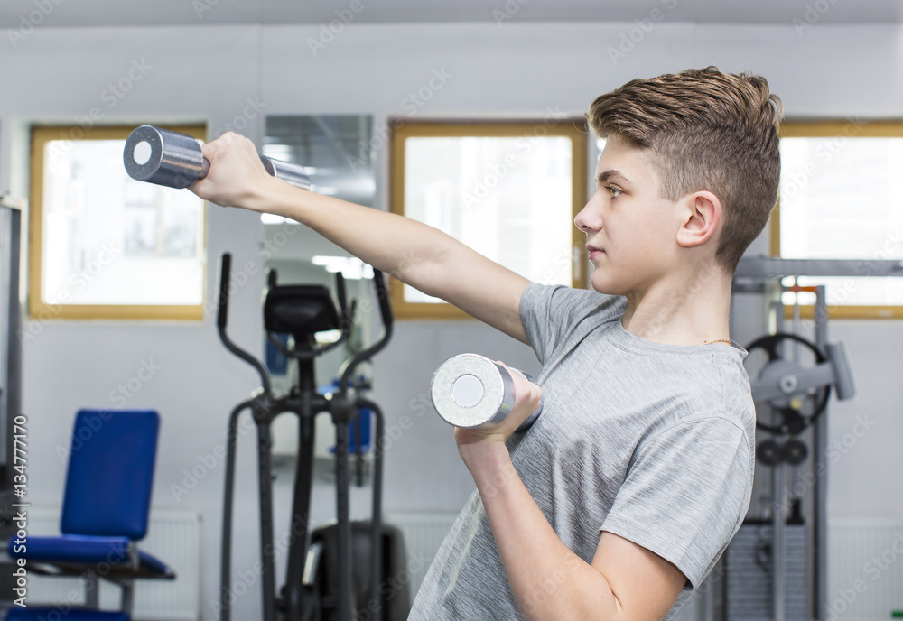 Teenage boy engaged in the gym hall